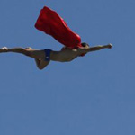 A man dressed as Superman dives off the meter high dive in Barcelona