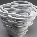 Vaso Vago - Vaso in marmo<br>Produzione Up-group - 2008<br>E' un vaso che apparentemente non ci rivela una sua logica interna. La sua forma  la naturale conseguenza della modalit di lavorazione con cui sono stati ottenuti i pezzi che lo compongono. I 24 anelli che formano il vaso sono ricavati da tre lastre di cm. 60 x 60 in marmo bianco di Carrara tagliate a getto d'acqua. La disposizione concentrica degli anelli sulla lastra consente di ridurre nei limiti del possibile gli scarti di materiale lavorato