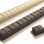 Golosimetro - Cioccolato fondente e bianco - Modello realizzato per la mostra "Strumenti di misura dei designr", Udine - Prodotto da Costruttori di dolcezze, 2002. Stecca di cioccolato + metro = una combinazione di due tipologie per misurare la nostra golosità